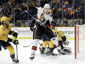 The Ottawa Senators' Brady Tkachuk (7) tries to control a rebound in front of the Nashville Predators' Ryan Hartman (38) in the first period of an NHL hockey game Tuesday, Dec. 11, 2018, in Nashville.