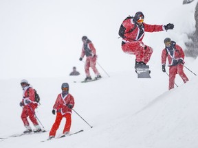 Skiers dressed as Santa Claus enjoy the slopes.