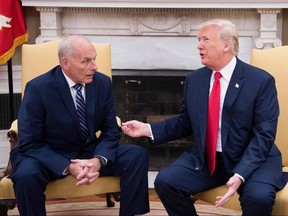 In this file photo taken July 31, 2017, U.S. President Donald Trump (right) speaks with newly sworn-in White House Chief of Staff John Kelly at the White House in Washington.