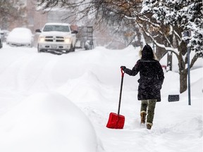 A woman shoves along Adelaide Street after Ottawa was hit with a winter storm Sunday Jan. 20, 2019.