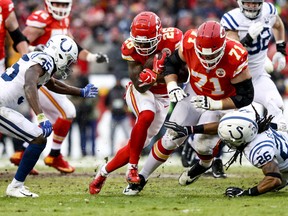 Damien Williams of the Kansas City Chiefs runs behind the block of teammate Mitchell Schwartz against the Indianapolis Colts during the first quarter of the AFC Divisional Round playoff game at Arrowhead Stadium on Jan. 12, 2019 in Kansas City, Missouri. (Jamie Squire/Getty Images)
