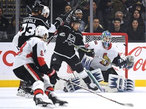 Goalie Anders Nilsson of the Ottawa Senators and Brendan Leipsic #14 of the Los Angeles Kings watch a shot from the point during the first period at the Staples Center on Thursday, Jan. 10, 2019 in Los Angeles.