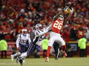 Damien Williams #26 of the Kansas City Chiefs jumps for a catch against  Elandon Roberts #52 of the New England Patriots in the second half during the AFC Championship Game at Arrowhead Stadium on January 20, 2019 in Kansas City, Missouri.