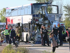 Firefighters and police work at the scene of a horrific crash between an OC Transpo double-decker bus and a VIA train near the Fallowfield station in Barrhaven in September 2013.