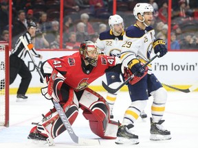 Craig Anderson of the Ottawa Senators defends his crease against #22 Johan Larsson and #29 Jason Pominville of the Buffalo Sabres during second period of NHL action at Canadian Tire Centre in Ottawa, March 08, 2018.