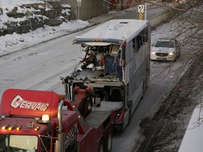 The OC Transpo bus involved in the crash at Westboro station was towed from the scene, revealing extensive damage, on Jan. 12, 2019.