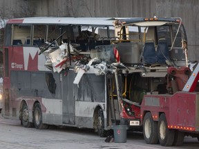 The OC Transpo bus involved in the crash at the Westboro station was towed from the scene, revealing extensive damage, on Jan. 12, 2019.