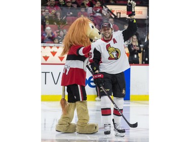 Ottawa Senator Zack Smith waves to the crowd after he slipped and fell on a carpet at the skills competition.