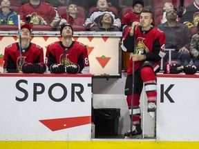 Centre Jean-Gabriel Pageau, right, watches the on-ice action from the bench during the Senators' annual skills competition on Thursday night. Injured in training camp, Pageau is expected to make his 2018-19 regular-season debut against the Hurricanes on Sunday.