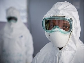 A member of the medical staff of the Ebola Treatment Unit (ETU)poses as she wears a Personal Protective Equipment (PPE).