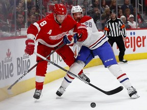 Canadiens defenceman Jeff Petry battles for the puck with Wings' Justin Abdelkader, left, during second period in Detroit on Tuesday night.