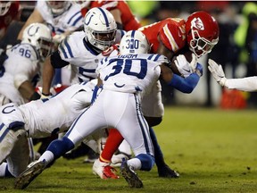 Kansas City Chiefs running back Darrel Williams, right, pushes his way to the end zone against Indianapolis Colts defensive back George Odum (30), during the second half of an NFL divisional football playoff game in Kansas City, Mo., Saturday, Jan. 12, 2019.