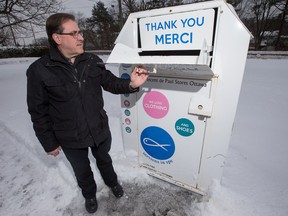 Richard Pommainville, executive director of the Saint Vincent de Paul Society, with one of the organization's donation bins.