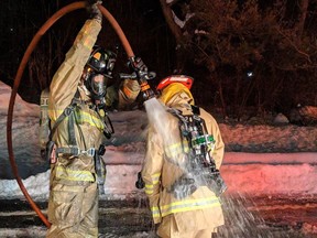 An Ottawa firefighter undergoes a decontamination protocol following the second-floor fire in the Steacie Building on the Carleton University campus on the night of Saturday, Jan. 26, 2019.