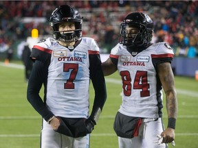 Redblacks starting quarterback Trevor Harris, left, and receiver R.J. Harris leave the field after their team lost the Grey Cup game against the Stampeders in Edmonton on Nov. 25.