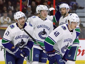The Vancouver Canucks' Sven Baertschi (47) celebrates his goal with teammates, including Elias Petterson (40), who had the hat trick against the Ottawa Senators on Wednesday, Jan. 2, 2019.