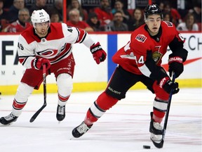 Ottawa Senators' Jean Gabriel Pageau moves the puck ahead of Carolina Hurricanes' Victor Rask during first period NHL hockey play on Sunday.