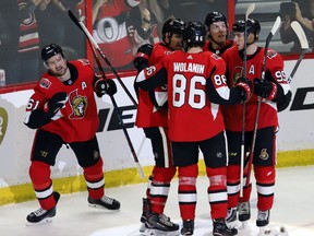 Senators winger Mark Stone, left, celebrates after scoring a third-period goal to cut the Wild's lead to 4-3 in the third period of Saturday's game. That, however, was as close as the Senators would get before time expired.