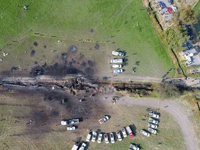 The ground is scorched where an oil pipeline exploded in Tlahuelilpan, Hidalgo state, Mexico, Saturday, Jan. 19, 2019. A massive fireball that engulfed people scooping up fuel spilling from a pipeline ruptured by thieves in central Mexico killed dozens of people and badly burned many more.