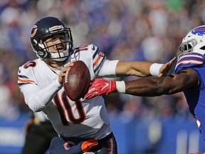 In this Nov. 4, 2018, file photo, Chicago Bears quarterback Mitchell Trubisky (10) tries to fend off Buffalo Bills' Julian Stanford during the first half of an NFL football game in Orchard Park, N.Y.