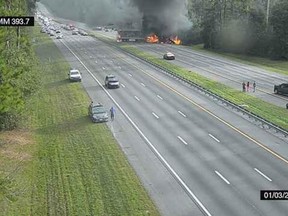 This image taken from a Florida 511 traffic camera and provided by the Alachua County Fire Rescue, shows a fiery crash along Interstate 75, Thursday, Jan. 3, 2019, about a mile south of Alachua, near Gainesville, Fla.