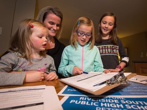 Laurie Rogers, pictured here with her daughters (from left) Jillian, 4, Chelsea, 7, and Rachel, 10, is leading a petition drive to try to convince the province to fund a new public high school in Riverside South.