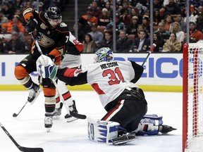 Ottawa Senators goaltender Anders Nilsson stops a shot next to the Anaheim Ducks' Andrew Cogliano during the second period on Wednesday, Jan. 9, 2019, in Anaheim, Calif.