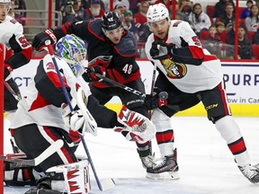 Carolina Hurricanes' Jordan Martinook (48) works between Ottawa Senators goaltender Anders Nilsson (31) and Senators defenceman Cody Ceci (5) during the first period on Friday, Jan. 18, 2019 in Raleigh, N.C.