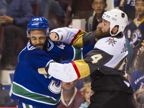 Darren Archibald fights Vegas Golden Knight Clayton Stoner during a Canucks game earlier this season.