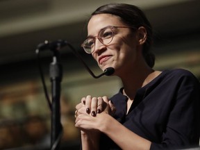 In this Dec. 6, 2018 file photo, Democrat Alexandria Ocasio-Cortez, who won her bid for a seat in the House of Representatives in New York's 14th Congressional District, asks 2014 Nobel Laureate Malala Yousafzai a question at the Kennedy School's Institute of Politics at Harvard University in Cambridge, Mass. (AP Photo/Charles Krupa)