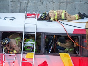 First responders attend to victims of a horrific rush hour bus crash at the Westboro Station near Tunney's Pasture.