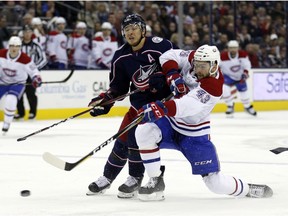 Canadiens' Michael Chaput, right, shoots the puck against Columbus Blue Jackets' Cam Atkinson in Columbus, Ohio, on Friday, Jan. 18, 2019.