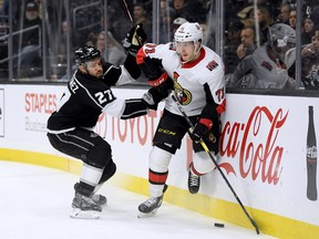 Kings’ Alec Martinez (left) and Sens’ Chris Tierney battle 
along the boards on Thursday night in Los Angeles. (GETTY IMAGES)