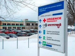 Some of the English words on the sign at the regional hospital have been covered Wednesday, Jan. 9, 2019 in Lachute, Que. Administrators of the hospital 80 kilometres northwest of Montreal announced they would eliminate the English signs that have been posted for years in order to comply with Quebec's language law, Bill 101.