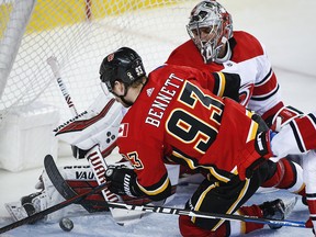 Carolina Hurricanes goalie Petr Mrazek, right, blocks the net on Calgary Flames' Sam Bennett in Calgary, Tuesday, Jan. 22, 2019. (THE CANADIAN PRESS/Jeff McIntosh)