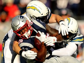 Sony Michel of the New England Patriots carries the ball during the first quarter in the AFC Divisional Playoff Game against the Los Angeles Chargers at Gillette Stadium on Jan. 13, 2019 in Foxborough, Mass. (Elsa/Getty Images)