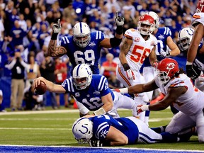 Colts quarterback Andrew Luck scores a touchdown in the fourth quarter of a wild-card game against the Chiefs in 2014. The Colts erased a 31-10 first-half deficit to win that game. The teams meet again on Saturday in the divisional round. (GETTY IMAGES)