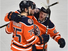 From left, Edmonton Oilers defenceman Evan Bouchard celebrates scoring his first NHL goal with teammates Tobias Rieder and Kailer Yamamoto on Oct. 25, 2018, against the Washington Capitals at Rogers Place.