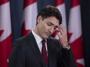 Canadian Prime Minister Justin Trudeau scratches his forehead during an end of session news conference in Ottawa on Wednesday, Dec. 19, 2018. THE CANADIAN PRESS/Adrian Wyld