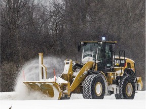 A loader plows the snow.