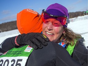 JoAnn Hanowski celebrates with her husband after finishing first in the women's division in the 27K Classic race during the Gatineau Loppet on Saturday, Feb. 16, 2019.