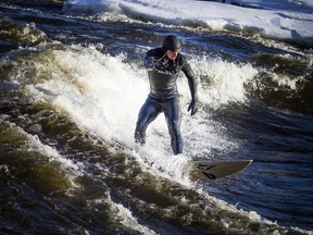 Pierre-Karl Sanscartier surfing on the Ottawa River Saturday Feb. 16, 2019.   Ashley Fraser/Postmedia