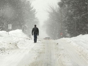 A man makes his way down Abbott Street in Stittsville. Ottawa is bracing for another huge dump of snow.