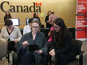 Federal public servants Nathalie Poirier, left, and Jessica Gladu try potential replacements for the Phoenix pay system on Monday, February 04, 2019.
