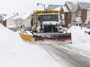 A snowplow clears Beatrice Drive following a winter storm in Ottawa on Wednesday, Feb. 13, 2019.