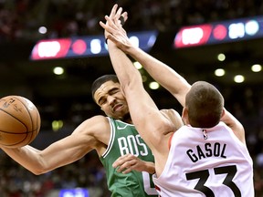 Boston Celtics forward Jayson Tatum commits an offensive foul against Raptors centre Marc Gasol during Tuesday night’s game. (THE CANADIAN PRESS)