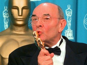 In this March 23, 1998 file photo, director Stanley Donen kisses the Oscar he received for Lifetime Achievement backstage at the 70th Academy Awards at the Shrine Auditorium in Los Angeles. (AP Photo/Reed Saxon, File)