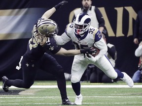 Los Angeles Rams' C.J. Anderson is stopped by New Orleans Saints' Alex Anzalone during the NFC championship game, Sunday, Jan. 20, 2019, in New Orleans. (AP Photo/David J. Phillip)