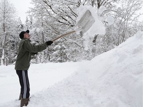 A man shovels snow.