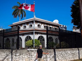 A man walks beside Canada's embassy in Havana, Cuba, Tuesday, April 17, 2018.